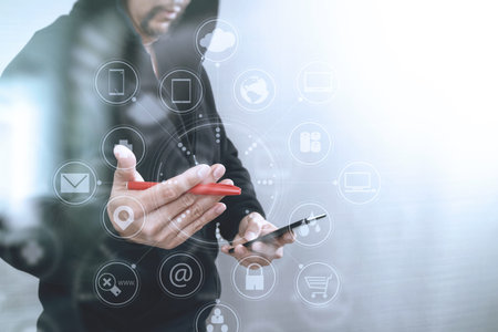 hipster male in a hood hand using mobile phone payments online shopping,omni channel,front...