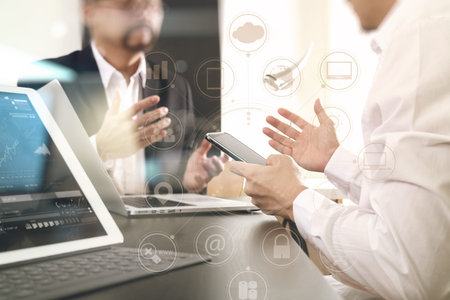 Co working team meeting concept,businessman using smart phone and digital tablet and laptop computer...