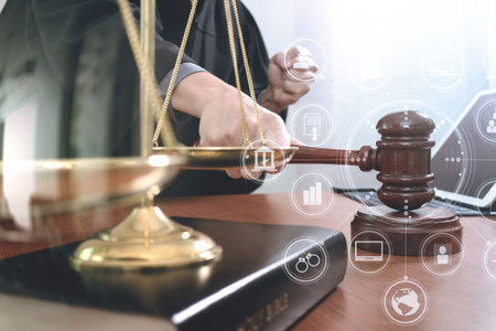 justice and law concept.Male judge in a courtroom with the gavel,working with smart phone and...