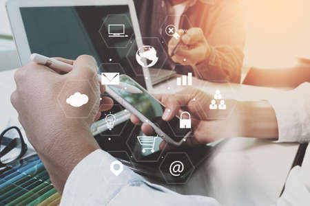 co working team meeting concept,businessman using smart phone and laptop and digital tablet computer in modern office with virtual interface icons network diagramの写真素材