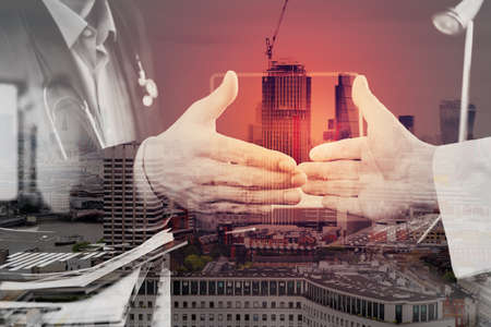 Double exposure of Medical and health care concept,Doctor and patient shaking hands in modern office at hospital,London cityの写真素材