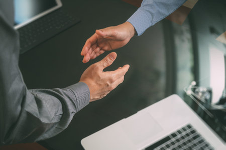 Medical and healthcare concept,Doctor and patient shaking hands in modern office at hospital