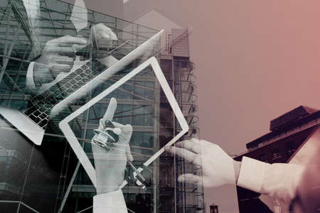 Medical co working concept,Doctor working with smart phone and digital tablet and laptop computer to meeting his team in modern office at hospital with London city exposureの写真素材