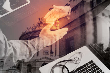 Double exposure of Medical and healthcare concept,Doctor and patient shaking hands in modern office at hospital,London cityの写真素材