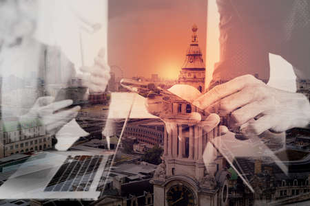 co working team meeting concept,businessman using smart phone and digital tablet and laptop computer in modern office with London city exposureの写真素材