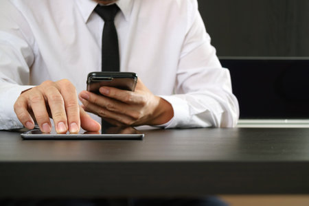 lawer working with smart phone and digital tablet computer in modern office
