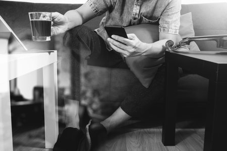 hipster hand using smart phone,digital tablet docking keyboard,coffee cup, payments online...