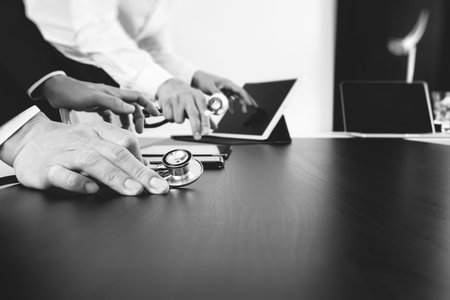 Medical co working concept,Doctor working with smart phone and digital tablet and laptop computer to...