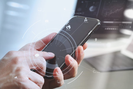 close up of businessman hand working with mobile phone and laptop and digital tablet computer in...