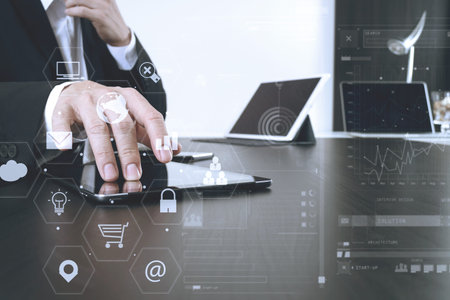 businessman working with smart phone and digital tablet and laptop computer in modern office with...