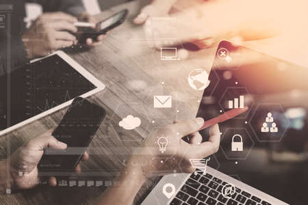 co working team meeting concept,businessman using smart phone and laptop and digital tablet computer in modern office with virtual interface icons network diagramの写真素材