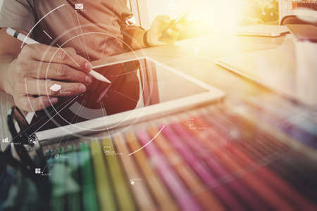 businessman working with mobile phone and digital tablet and laptop computer on wooden desk in modern office with virtual icon diagramの写真素材