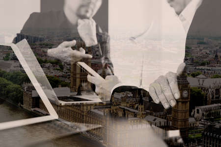 Co working team meeting concept,businessman using smart phone and digital tablet and laptop computer in modern office with London city exposureの写真素材