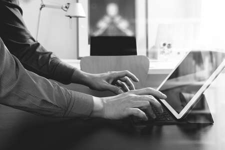 businessman or Designer using digital tablet computer on black desk in modern office,black and whiteの写真素材