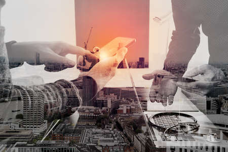 Medical co working concept,Doctor working with smart phone and digital tablet and laptop computer to meeting his team in modern office at hospital with London city exposureの写真素材