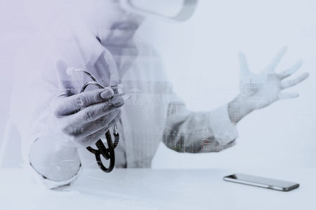 smart doctor wearing virtual reality goggles in modern office with mobile phone using with VR...