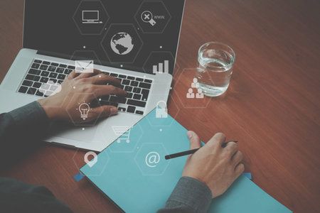 top view of  businessman hand working with laptop computer and book with VR business strategy...