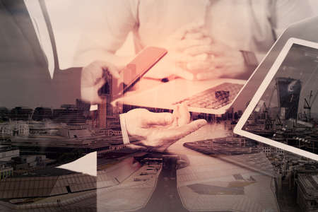 co working team meeting concept,businessman using smart phone and digital tablet and laptop computer in modern office with London city exposureの写真素材