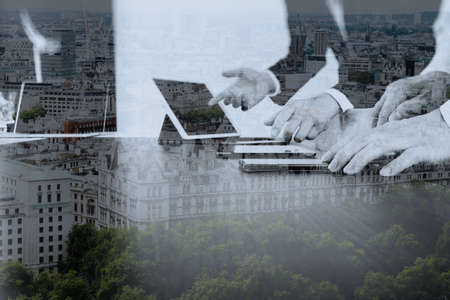 co working team meeting concept,businessman using smart phone and digital tablet and laptop computer in modern office with London city exposureの写真素材