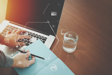 top view of  businessman hand working with laptop computer and book with VR business strategy...