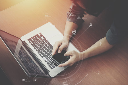 top view of  businessman hand working with laptop computer and mobile phone with VR business...