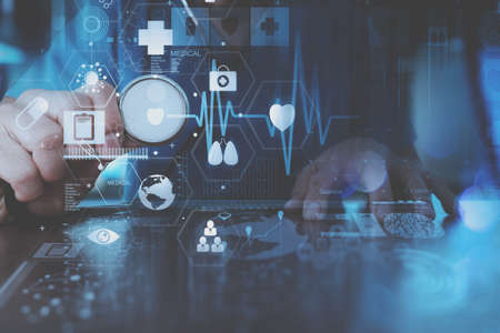 medical techonlogy concept,smart doctor hand working with modern laptop computer in modern office with virtual icon diagramの写真素材