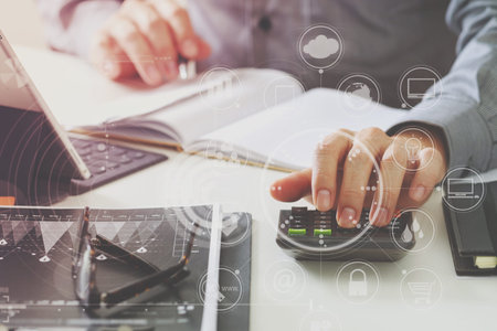 businessman hand working with finances about cost and calculator and latop with mobile phone on...