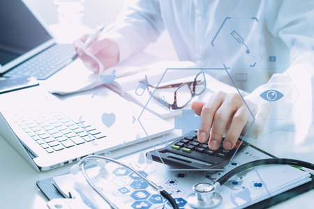 Healthcare costs and fees concept.Hand of smart doctor used a calculator for medical costs in modern...