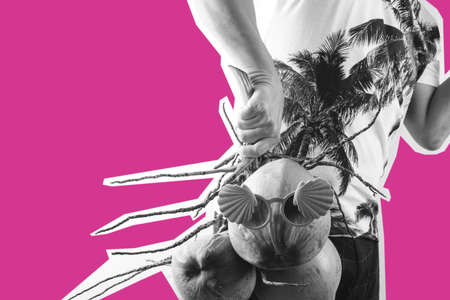 Summer and holiday fashion concept.Man Wearing palm trees graphics on T-shirt and holding cluster of coconuts with items,black and white on pink backgroundの写真素材