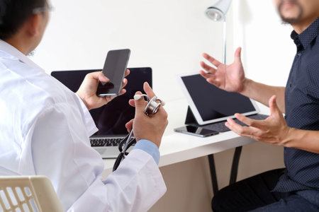 Medical doctor in white uniform gown coat consulting businessman patient having exam as Hospital...