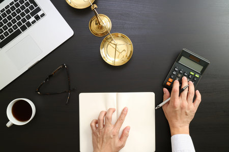 justice and law concept.businessman or lawyer or accountant working on accounts using a calculator...