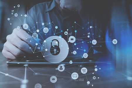 Cyber security internet and networking concept.Businessman hand working with VR screen padlock icon...