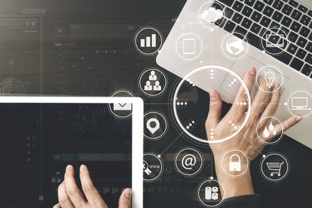 Cyber security internet and networking concept.Businessman hand working with VR screen padlock icon on laptop computer and digital tablet backgroundの写真素材