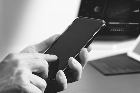 close up of businessman hand working with mobile phone and laptop and digital tablet computer in...