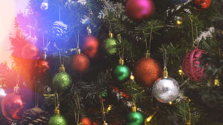 Greeting Season concept.close up of ornaments on a Christmas tree with decorative lightの写真素材