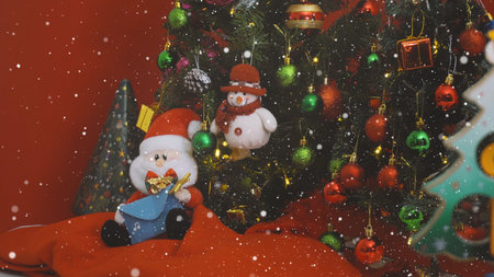 Greeting Season concept. Santa Claus and Snow man with ornaments on a Christmas tree with decorative lightの写真素材