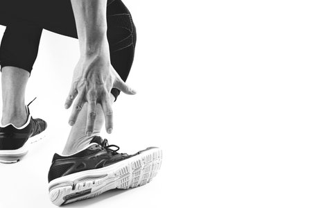 Runner sportsman holding ankle in pain with Broken twisted joint running sport injury and Athletic...