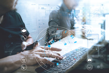 Businessmen working together on a document and using smart phone and digital tablet and laptop...