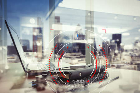Concept of focus on target with digital diagram,graph interfaces,virtual UI screen,connections netwoork.Workspace of excusive office in modern buildingの写真素材