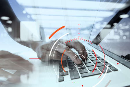 Concept of target focus digital diagram,graph interfaces,virtual UI screen,connections netwoork.Hipster finance analist working with laptop at trendy officeの写真素材