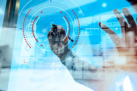 Double exposure of businessman hand working with new modern computer and business strategy as conceptの写真素材