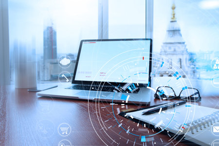 Office workplace with laptop and smart phone on wood table and london city blurred background with...