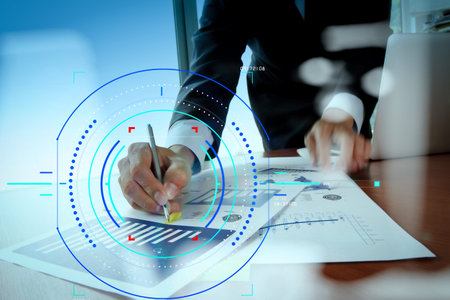 Concept of focus on target with digital diagram.Double exposure of businessman hand working with new...