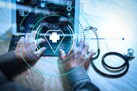 Health care and medical services with circular AR diagram.Medical technology concept. Doctor hand working with modern digital tablet dock screen computer with medical chart interfaceの写真素材