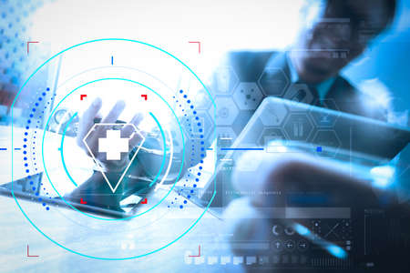 Health care and medical services with circular AR diagram.Medical technology network team meeting concept. Happy Doctor hand working smart phone keyboard docking digital tablet screen laptop computer.の写真素材