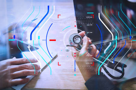 Health care and medical services with circular AR diagram record.Doctor hand working with smart phone modern digital tablet and laptop computer with graphics chart interface.の写真素材
