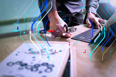 Health care and medical services with circular AR diagram record.Medical technology concept. Doctor hand working with modern digital tablet dock screen computer with medical chart interface.の写真素材