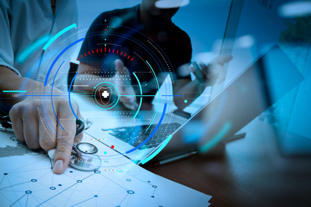 Health care and medical services with circular AR diagram record.Doctor working with digital tablet and laptop computer in medical workspace office and medical network media diagram as conceptの写真素材