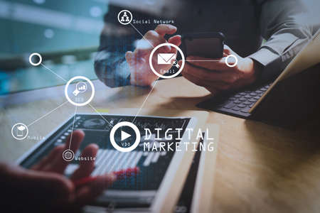 Digital marketing media (website ad, email, social network, SEO, video, mobile app) in virtual screen.businessman working with new modern computer show social network structure. の写真素材
