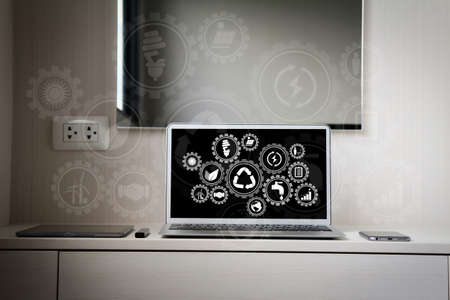Sustainable development with icons of renewable energy and natural resources preservation with environment protection inside connected gears.screen laptop computer and smart phone and digital tablet and stylus pen.の写真素材